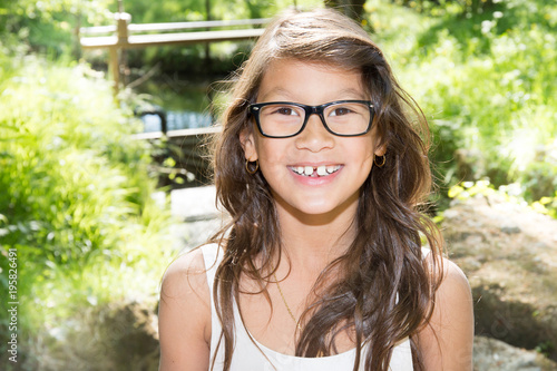 Beautiful smiling girl outdoor portrait with glasses