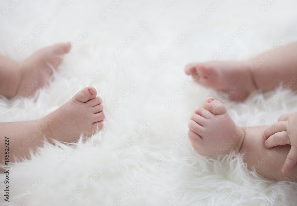 baby feet on white blanket. copy space. selective focus baby feet on white blanket. copy space. selective focus