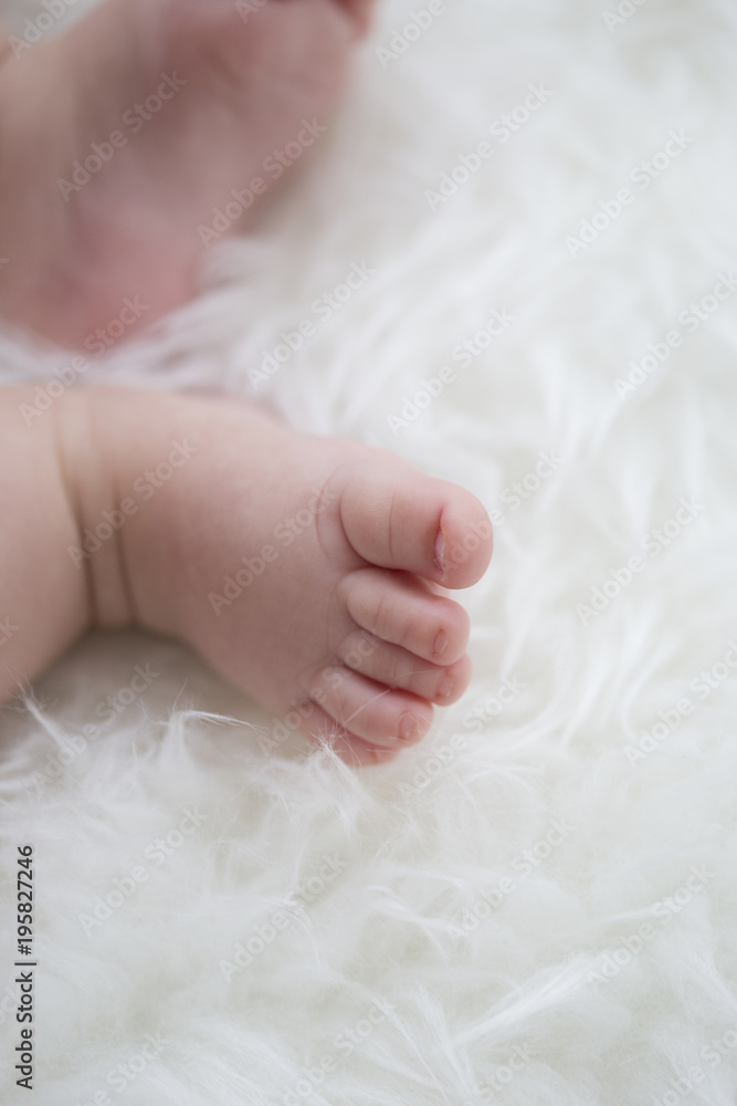 baby feet on white blanket. copy space. selective focus baby feet on white blanket. copy space. selective focus