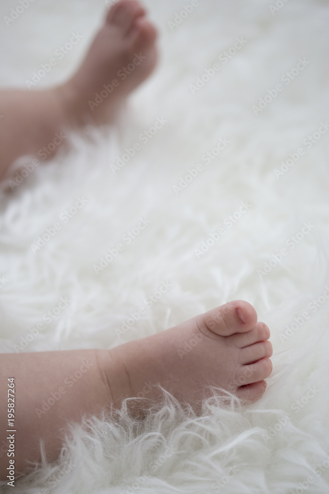 baby feet on white blanket. copy space. selective focus baby feet on white blanket. copy space. selective focus