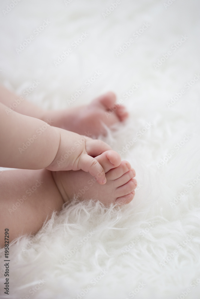baby feet on white blanket. copy space. selective focus baby feet on white blanket. copy space. selective focus