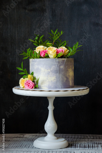 anniversary cake with roses on cake stand