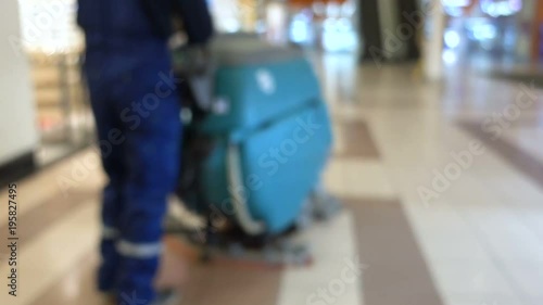 Cleaning in Shopping Center. Man With a Floor Cleaner Machine in the shopping center. Blurred background.	
