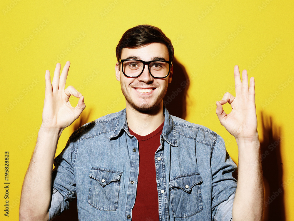 Portrait of a cheerful young man showing okay Portrait of a cheerful young man showing okay