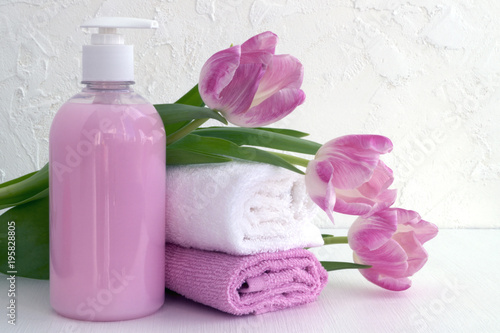 Liquid soap and two towels on a white background.