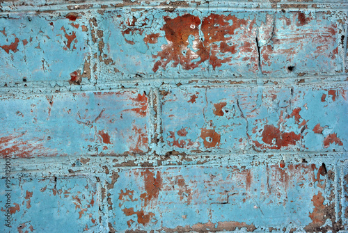 Bright blue color plaster on old brick wall, grunge texture background