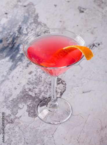 Top view red orange cocktail Margarita fresh in a martini glass on a gray background. Bar alcohol drink menu, delicious tequila sunrise long drink.