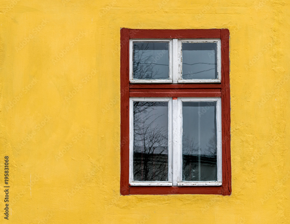 Old red window frame on a yellow wall Old red window frame on a yellow wall