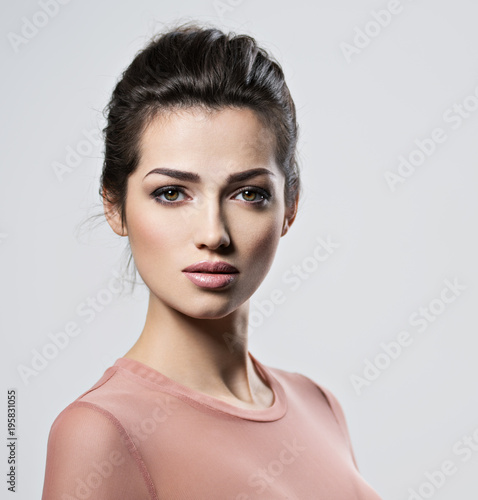 Portrait of an young beautiful  woman with  smoky eyes makeup.