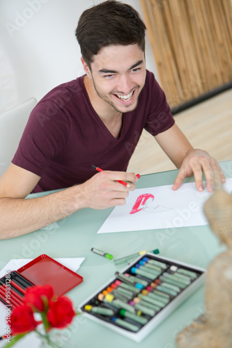 Artist laughing while drawing picture