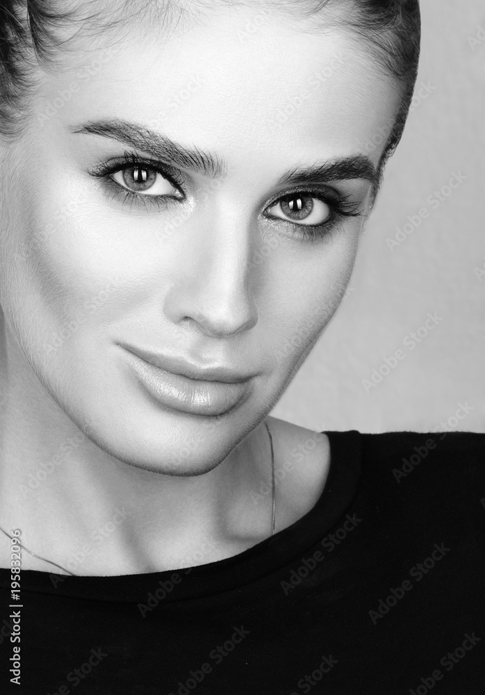 Fototapeta premium Black and white closeup beauty portrait of beautiful young woman with professional colourful make-up