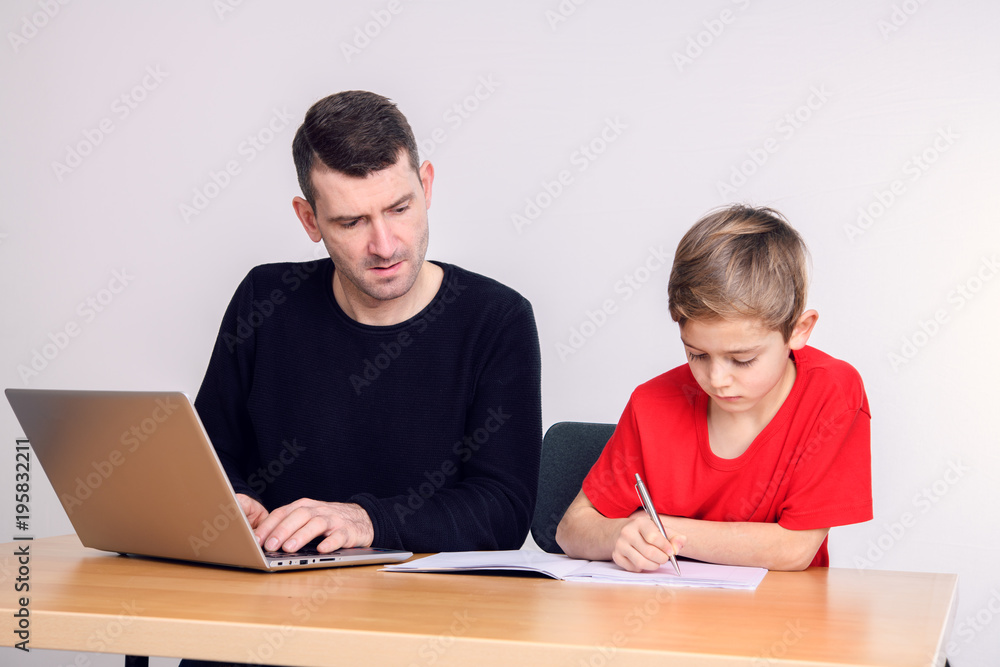 father and son using computer together father and son using computer together