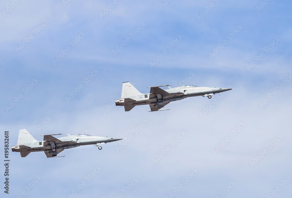 Obraz premium fighter jet military aircrafts flying with high speed on blue sky background