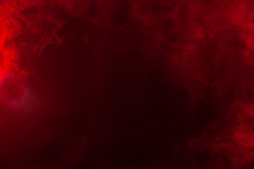 Red smoke or flame texture on a black background. Texture and abstract art