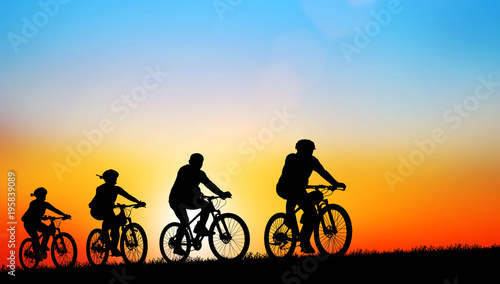 Silhouette group friend and bike relaxing on blurry sunset sky background.