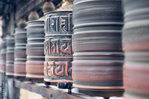 Buddhist prayer wheel in Swayambhunath temple. Nepal, Kathmandu. photo