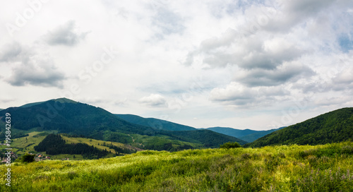 grassy meadow on a hump in mountains. lovely summer landscape on an overcast day