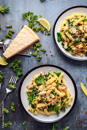 Homemade Pasta fusilli with Chicken, Green Kale, Garlic, lemon and parmesan cheese. healthy home food photo