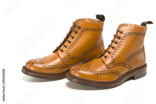 Male Footwear Ideas. Pair of Premium Tanned Brogue Derby Boots Made of Calf Leather with Rubber Sole. Isolated Over Pure White Background.