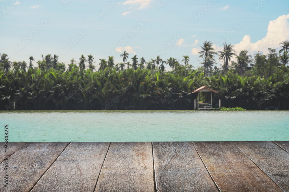 Fototapeta premium Selected focus empty brown wooden table and nature landscape blur background with bokeh image, for product display montage