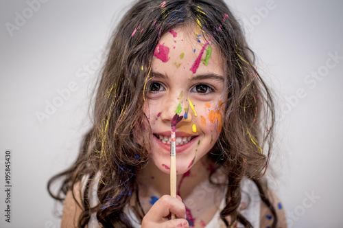 little girl smeared with paints