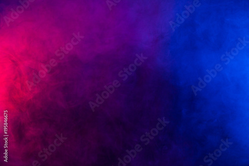 Blue and violet smoke texture on a black background. Texture and abstract art