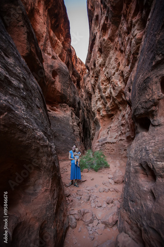 Mother and son on a trail in volcanic Snow canyon State Park in Utah, USA