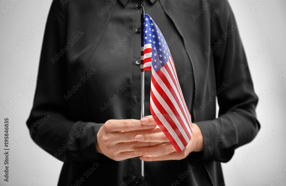 custom made wallpaper toronto digitalWoman holding American flag on light background. Immigration to USA