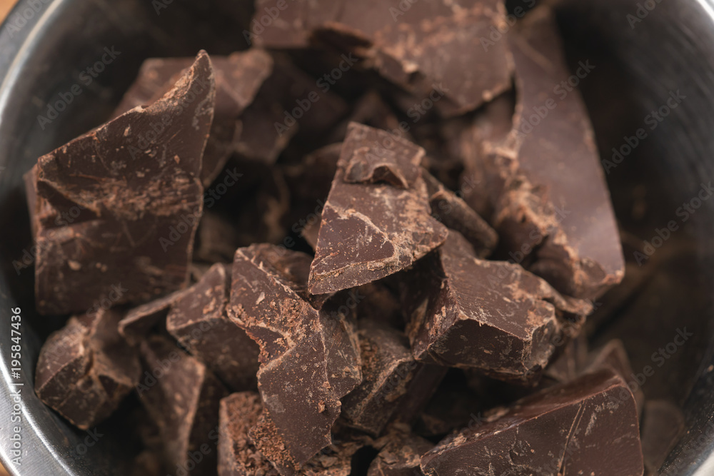 melting dark chocolate chunks in steel bowl melting dark chocolate chunks in steel bowl
