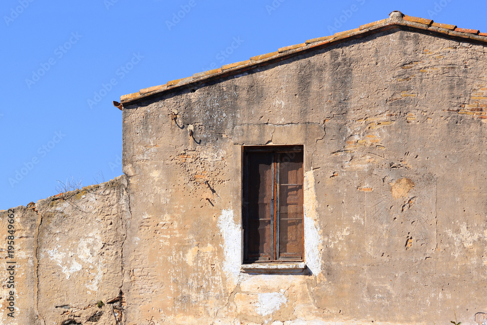 Damaged facade of a rural house used as a farmhouse tourism. Empty copy space for Editor's text. Damaged facade of a rural house used as a farmhouse tourism. Empty copy space for Editor's text.
