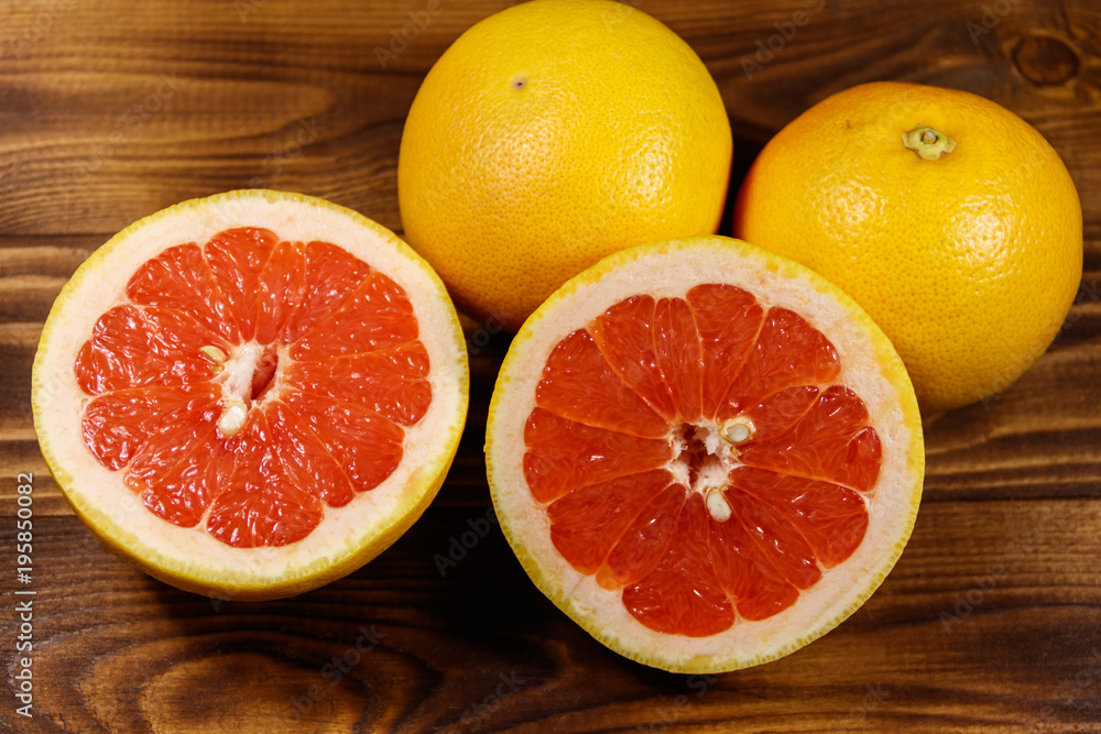 Ripe fresh grapefruits on wooden table Ripe fresh grapefruits on wooden table
