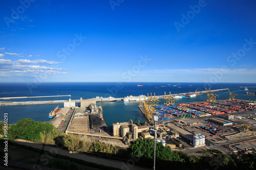 Panoramic view of the cargo port in Barcelona, sunset time, aerial view