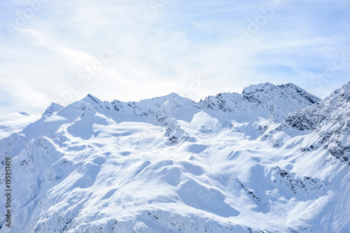 Top mountain glacier range Alps panoramic view with blue cloudy sky