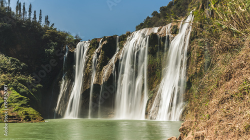 Waterfalls, Jiulong Waterfalls closeup with morning sky on background at Luoping County Town, China.