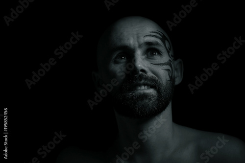 tattoo on the face, man with a tattoo, brutal bearded guy, studio portrait of a man