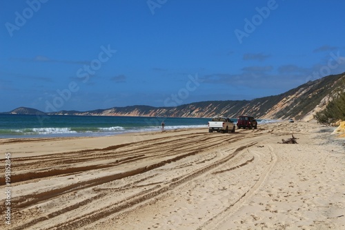 Lonely hiker along the well-known 4WD track at the colored sands cliffs in Rainbow Beach  Queensland  Australia