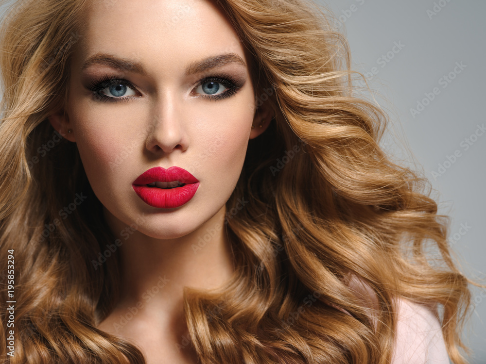 Fototapeta premium Beautiful young blond woman with sexy red lips.