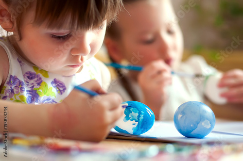 Schoolchildren painting eggs for Easter