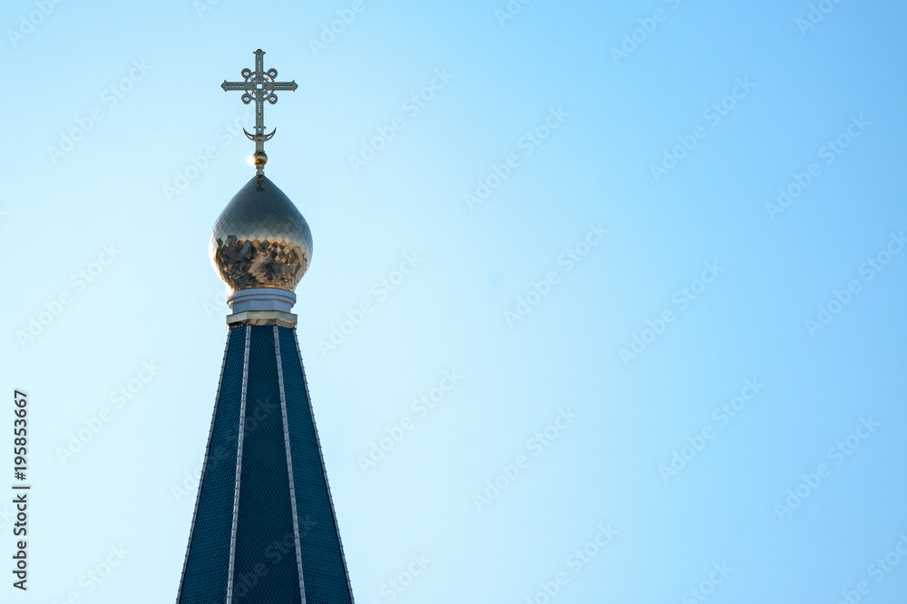 Orthodox cross on the dome of the Church against the clear blue sky Orthodox cross on the dome of the Church against the clear blue sky