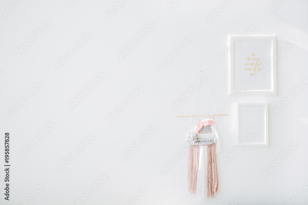 Minimal interior design concept. White wall, photo frames and decoration.