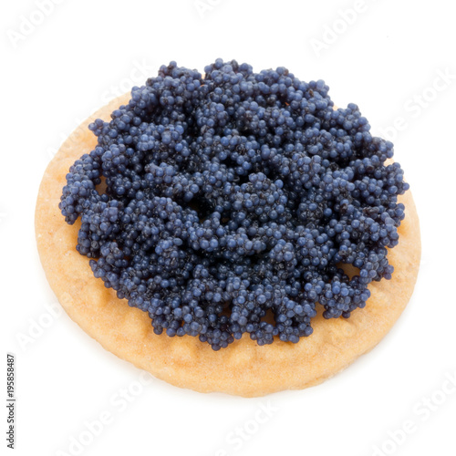 Canapes with black sturgeon caviar on the isolated white background.