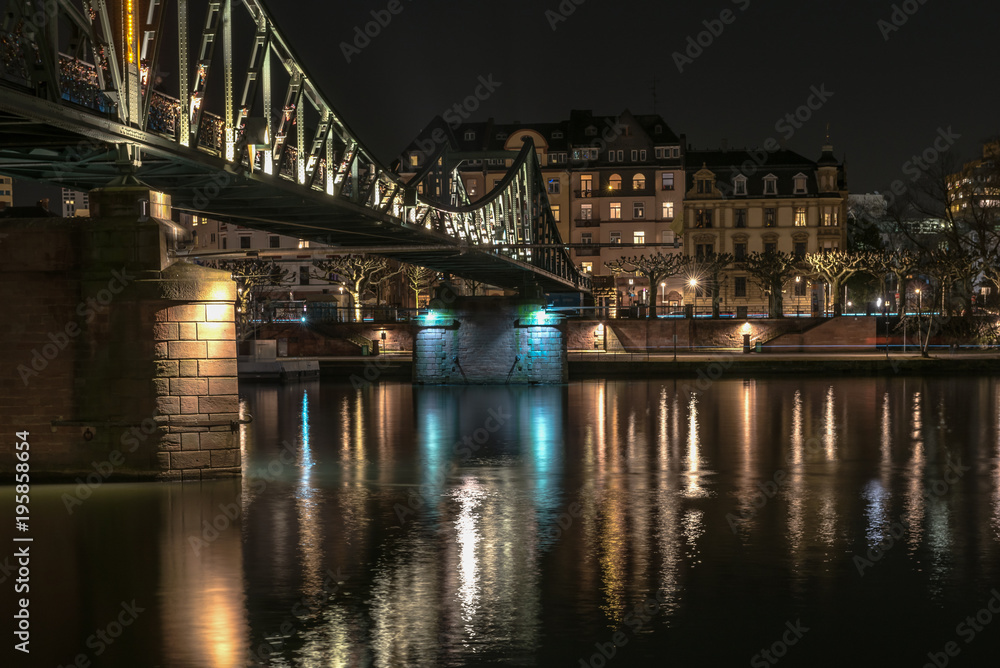 The iron bridge on Main river in Frankfurt during the night. Concept: architecture or travel and vacation