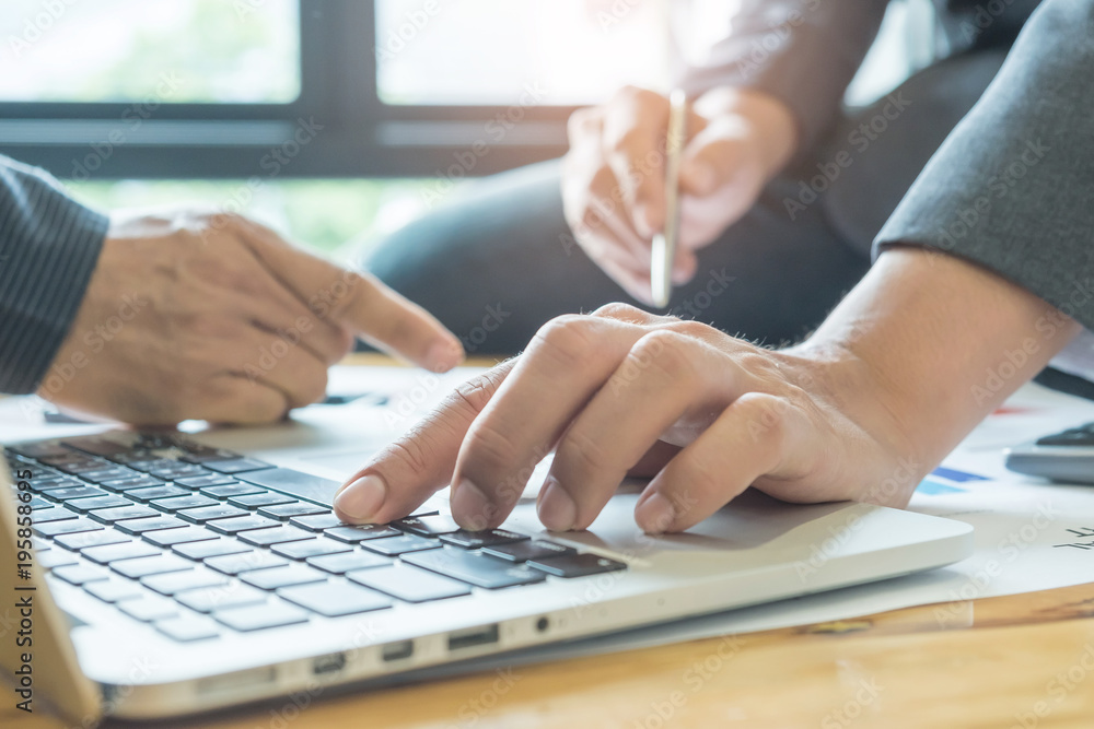 Business concepts,Two men use laptop analyze job,Pen in men's hand. Business concepts,Two men use laptop analyze job,Pen in men's hand.