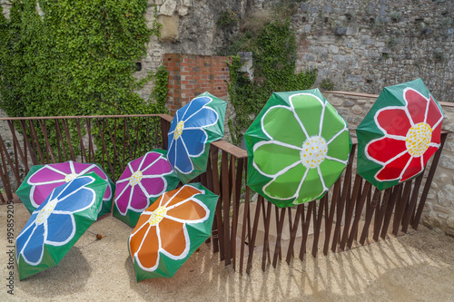 Decorated umbrellas in historic center of catalan city of Girona. In spring festival flowers 