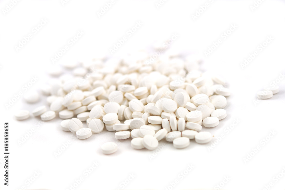 White round tablets close-up on white background White round tablets close-up on white background