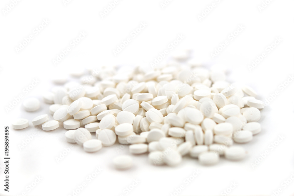 White round tablets close-up on white background White round tablets close-up on white background