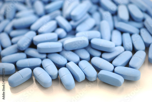 Blue oval tablets on white background