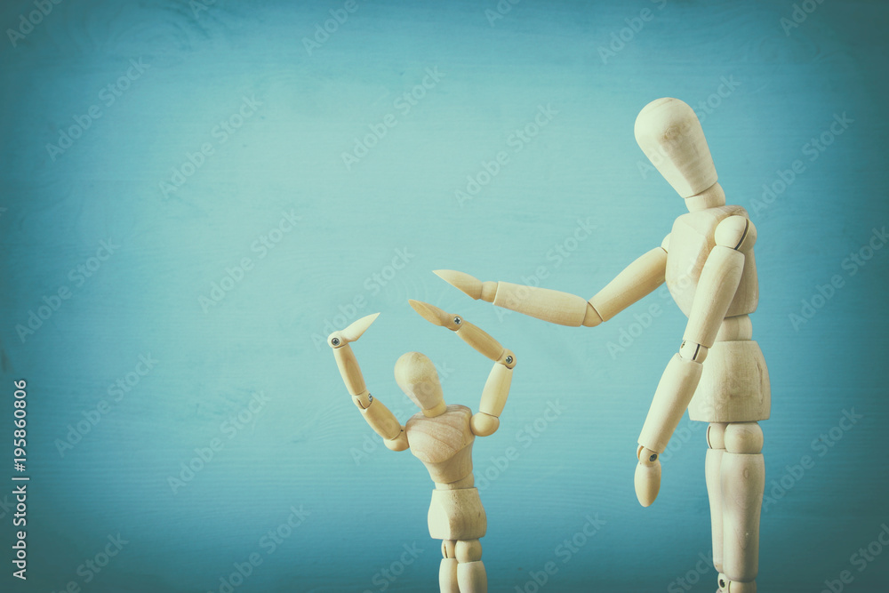 family violence cincept. wooden dummies as parents and child arguing and shouting. family violence cincept. wooden dummies as parents and child arguing and shouting.
