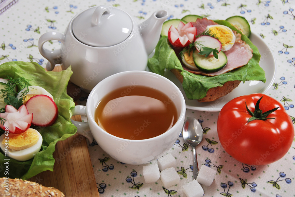 red tomato and sandwich with ham salad with egg and radish with hot tea for a healthy breakfast red tomato and sandwich with ham salad with egg and radish with hot tea for a healthy breakfast