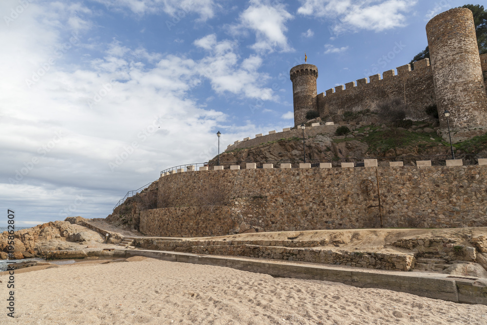 View of the beach and medieval walls and towers in Tossa de mar, Costa Brava, province Girona, Catalonia, Spain.